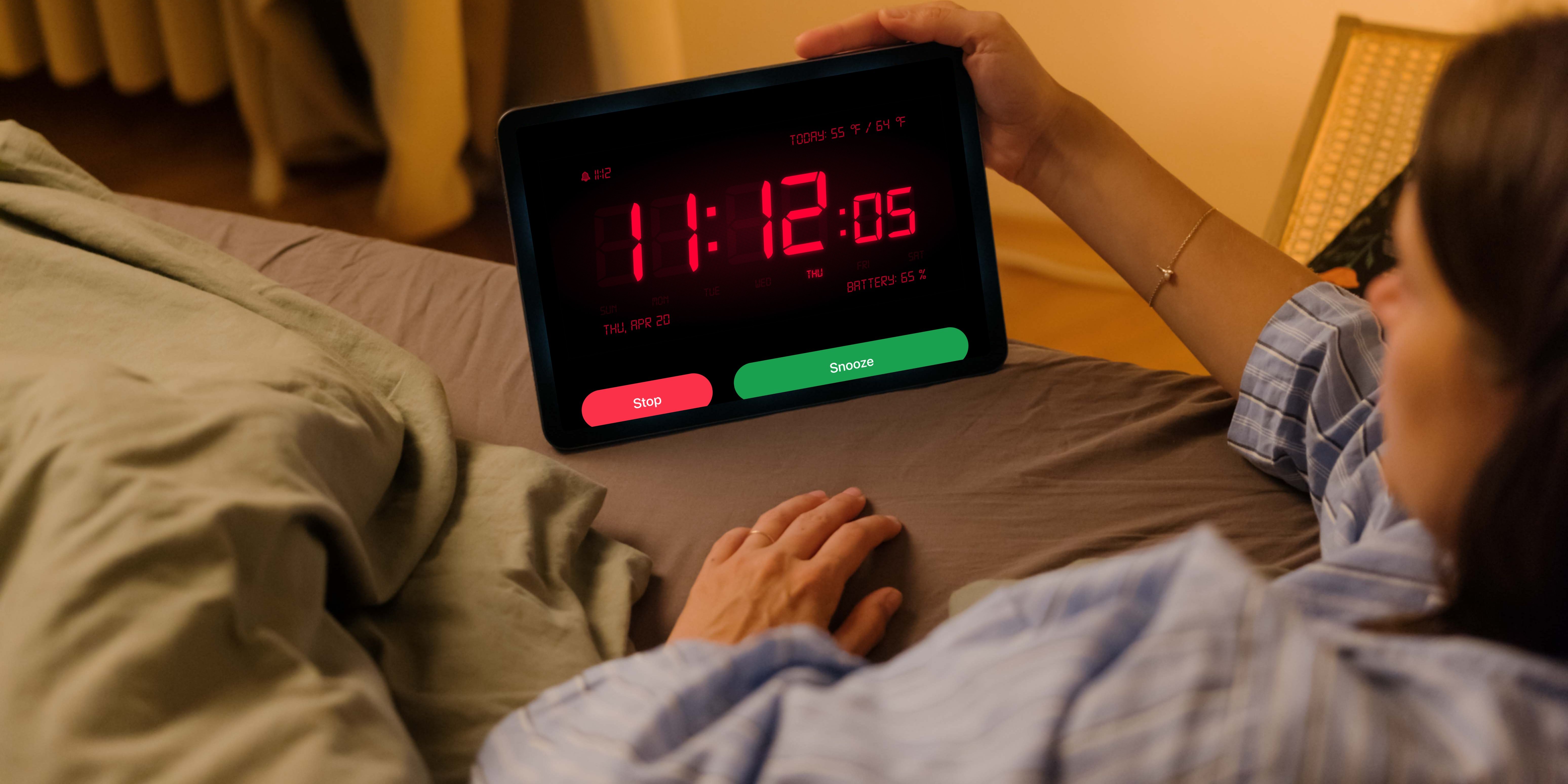 Una donna sdraiata a letto utilizza l'app Sveglia HD su iPad